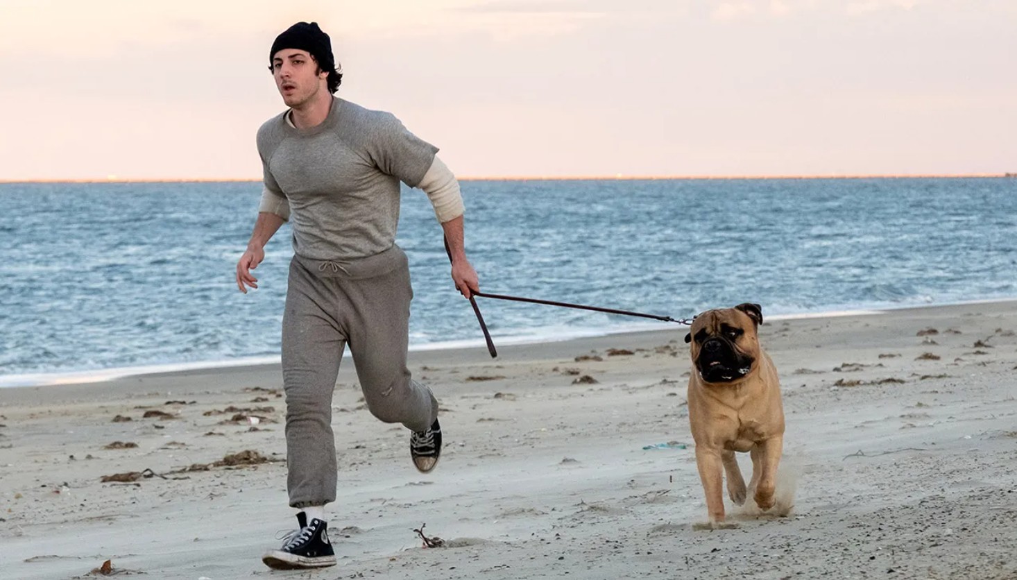 Anthony Ippolito as a young Sylvester Stallone running with a dog along the beach in I Play Rocky